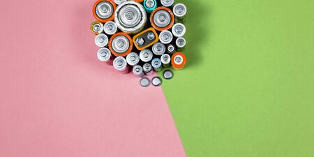 Ecology recycling concept. Many different types used or new battery, rechargeable accumulator, alkaline batteries on color background. Nature energyの写真素材