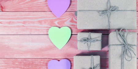 Gift boxes wrapped kraft paper tied with twine and sticker heart and tied with twine. with copy spaceの写真素材