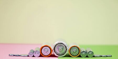 different types used or new battery, rechargeable accumulator, alkaline batteries on color background.の写真素材