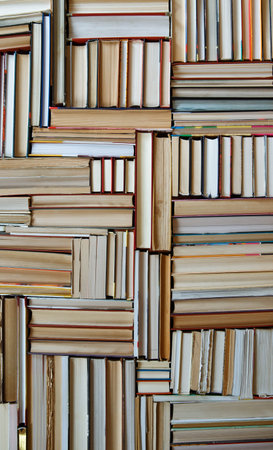 Many Books Piles. Hardback books on wooden table. Books stack texture and background. Back to...