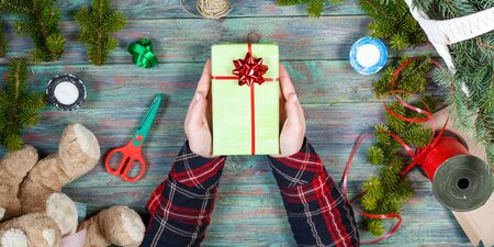 Making craft creative gift boxes, woman decorating Christmas presents with natural decorations, top viewの写真素材