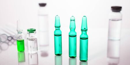 Group of vials with medication on blue methacrylate table. Horizontal composition.の写真素材