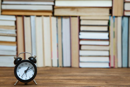 Many Books Piles. Hardback books on wooden table. Books stack texture and background. Back to...