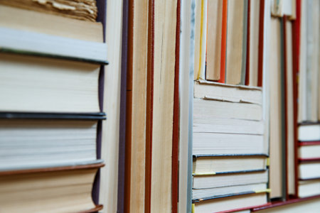 Many Books Piles. Hardback books on wooden table. Books stack texture and background. Back to...
