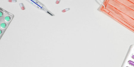 Treatment of colds and flu. Various medicines, a thermometer, sprays from a stuffy nose and a pain...