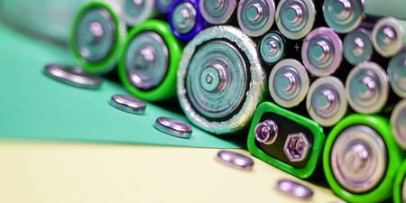 Ecology recycling concept. Many different types used or new battery, rechargeable accumulator, alkaline batteries on color background. Nature energyの写真素材