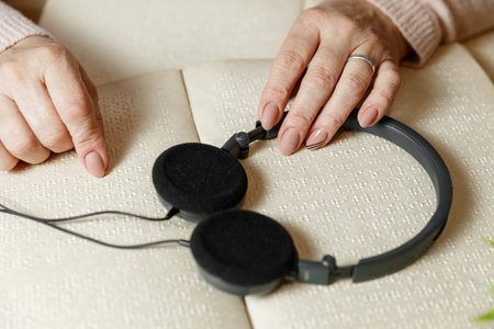 close up view of woman reading braille text on old book