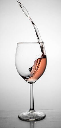 Red wine up and splash from a glassの写真素材