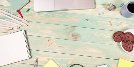 Blue office desk table with with office supplies. Top view with copy spaceの写真素材