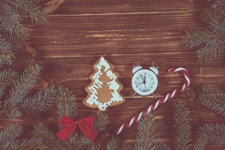 Christmas holiday background with vintage alarm-clock, Candy canes wooden background. Close-up, top view. Christmas and New Year conceptの写真素材