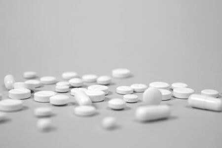 White medical pills on blue background. with a copy of spaceの写真素材