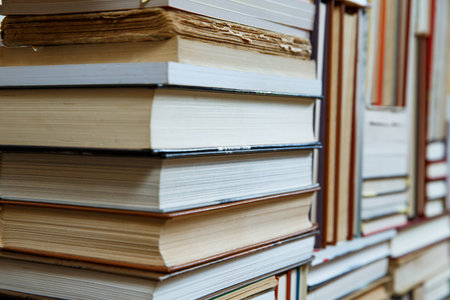 Many Books Piles. Hardback books on wooden table. Books stack texture and background. Back to...