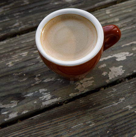 Cup of hot coffee on the wooden table. Energy drink for the whole day.. With copy space