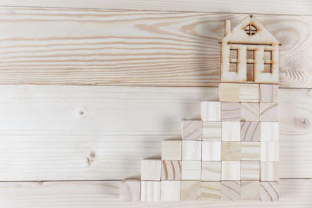 Real estate concept. Small toy wooden house with keys with copy spaceの写真素材