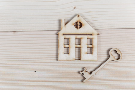 Real estate concept. Small toy wooden house with keys with copy spaceの写真素材
