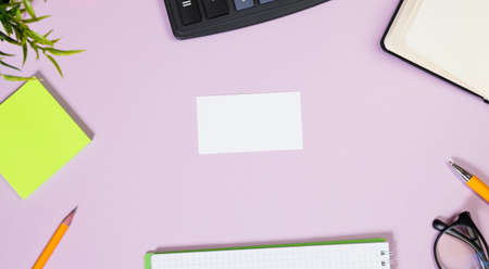 Office supplies in the pink workspace. Top view with copy space for input the text. Designer workspace on desk table essential elements on flat layの写真素材