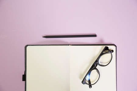 Office supplies in the pink workspace. Top view with copy space for input the text. Designer workspace on desk table essential elements on flat layの写真素材