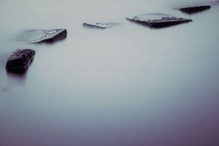 Beautiful stream flowing in motion. Natural background. Toning an imageの写真素材