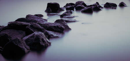 Beautiful stream flowing in motion. Natural background. Toning an imageの写真素材