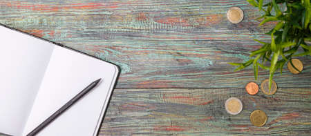 Office supplies in the wooden workspace. Top view with copy space for input the text. Designer workspace on desk table essential elements on flat layの写真素材