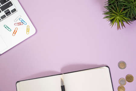 Office supplies in the pink workspace. Top view with copy space for input the text. Designer workspace on desk table essential elements on flat layの写真素材