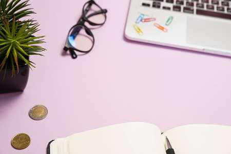 Office supplies in the pink workspace. Top view with copy space for input the text. Designer workspace on desk table essential elements on flat layの写真素材