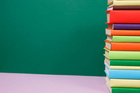 Composition with vintage old hardback books, colored background. Books stacking. Back to school. Copy Space. Education background.の写真素材