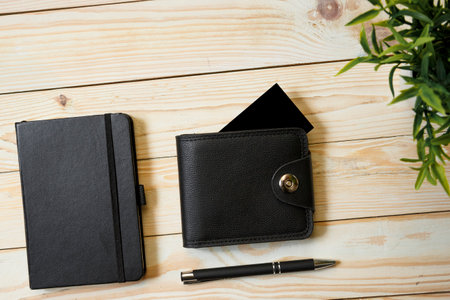 Business cards blank or bank card in a leather wallet. Mockup on wooden background. Copy space for textの写真素材