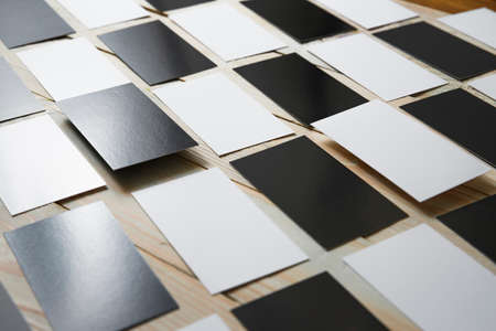 Business cards blank chess board concept. White and black mockup on wooden background. Flat Lay. copy space for textの写真素材