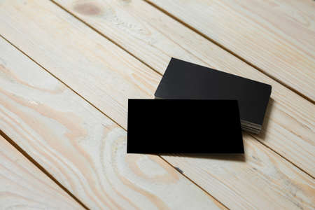 Business cards blank. Black mockup on wooden background. Flat Lay. copy space for textの写真素材