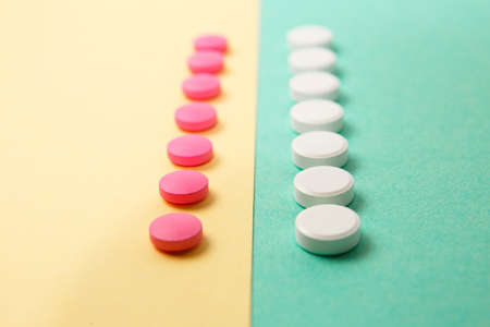 White and pink medicines on a colored double backgroundの写真素材