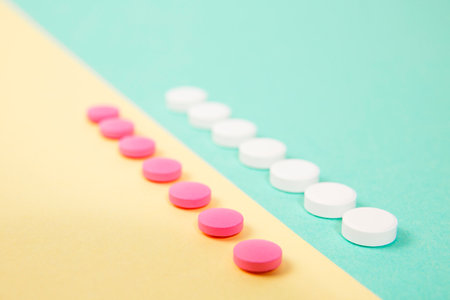 White and pink medicines on a colored double backgroundの写真素材