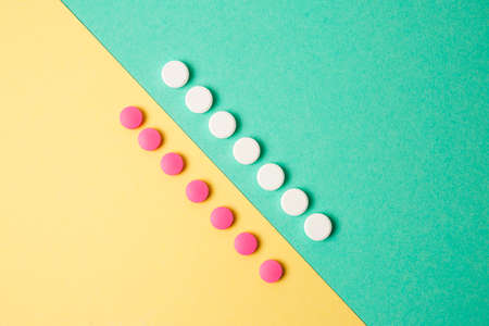 White and pink medicines on a colored double backgroundの写真素材