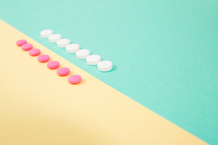White and pink medicines on a colored double backgroundの写真素材