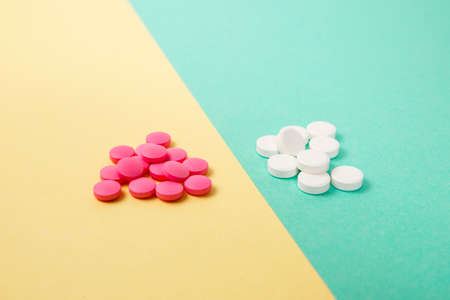 White and pink medicines on a colored double backgroundの写真素材