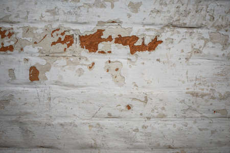 White painted old brick wall with red cracked bricks.の写真素材