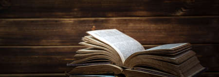 Old books on wooden shelf. Bookshelf history theme grunge background.の写真素材