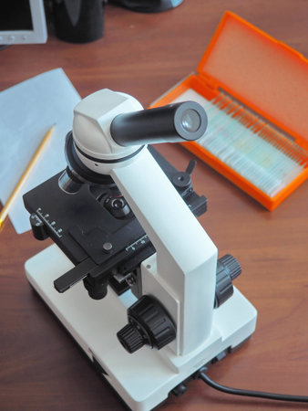 Modern optical microscope. Study, science and technology concept. Top view. Selective focus.