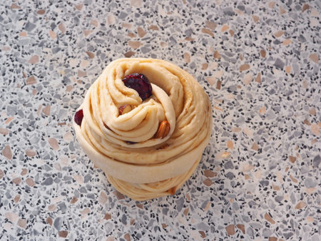 Cooking process. Preparing cruffin dessert. Modern homemade pastries. Puff dough swirl on kitchen...