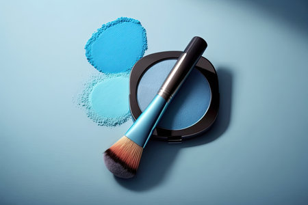makeup brush and eye shadow on blue background. AI Generatedの素材