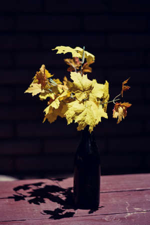 flowers as a center piece in a wine bottleの写真素材