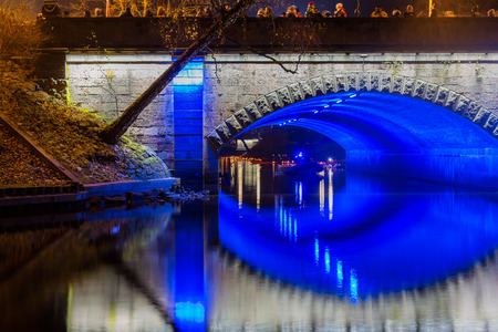 Blue lights under the bridge channel.Evening Rigaの写真素材