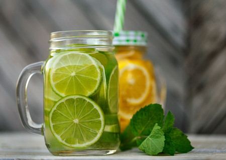 Lemonade in a glass mug-bank on the background of a wooden wallの写真素材