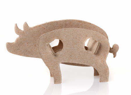 Cardboard toy pig, the symbol of the year on a white backgroundの写真素材