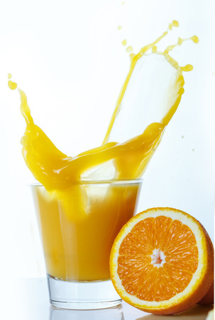 Orange juice with cut fruit on a white backgroundの写真素材