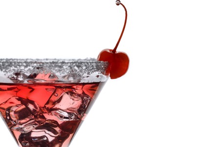 Fragment of a glass with a cocktail with ice and a cherryの写真素材