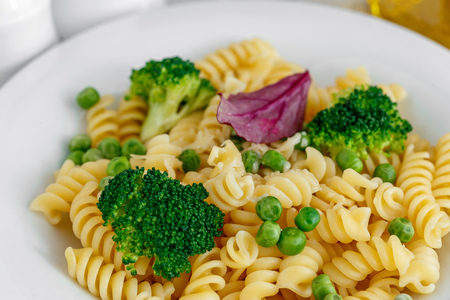 Pasta with broccoli and green peas in a plate close-upの写真素材