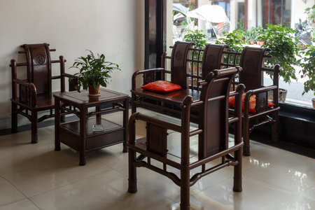 Chinese-style wooden furniture in a dark brown loungeの写真素材