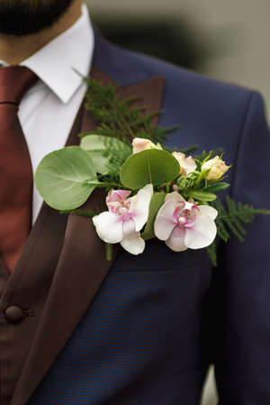 Groom's cBoutonniere on the groom's jacket of their orchids orsage - Flower Arrangement, orchid, roseの写真素材