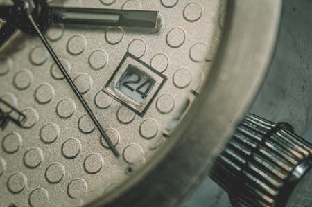 An old wristwatch with a scratched glass under magnificationの写真素材